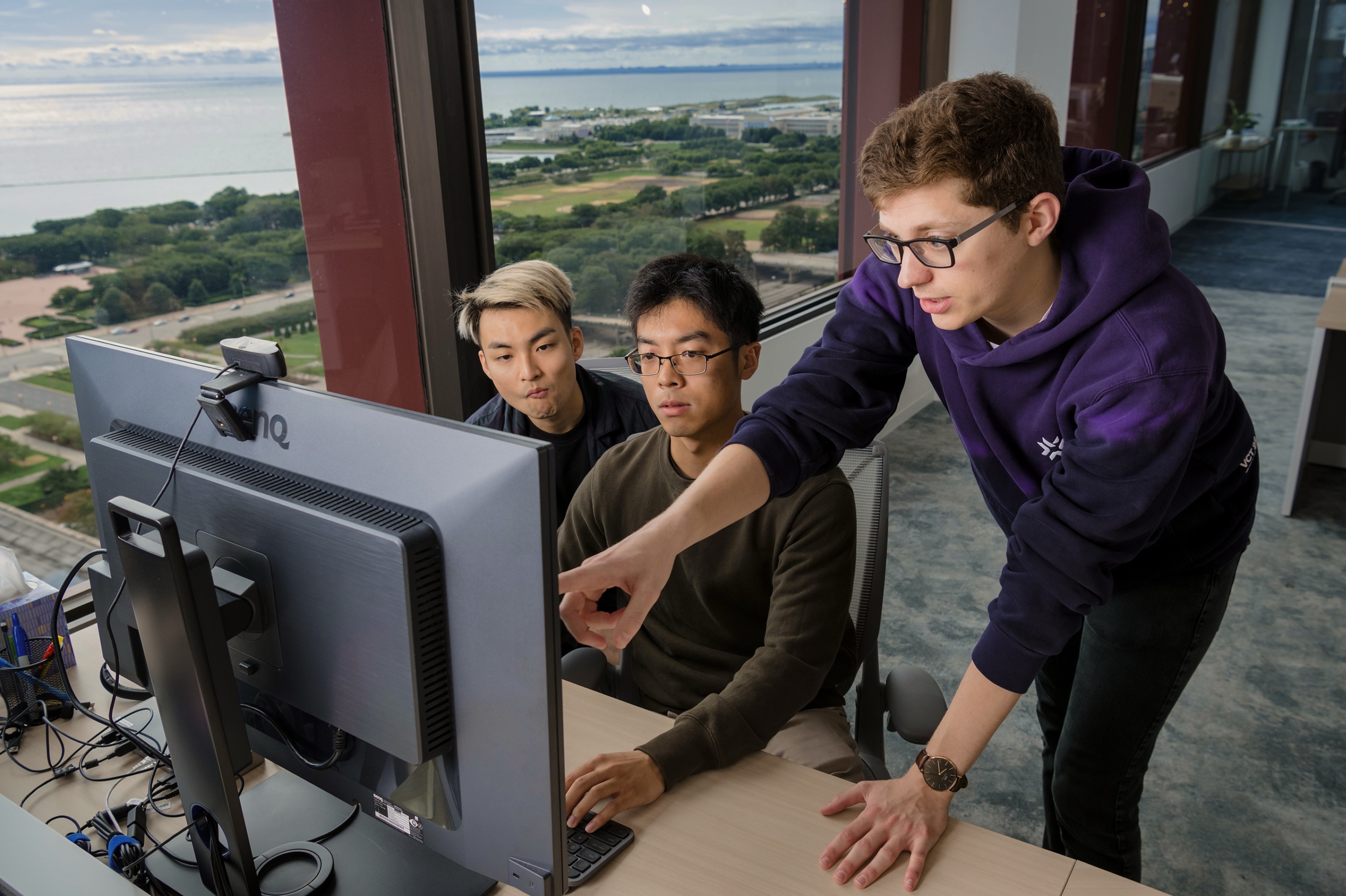 Diverse tech team reviewing work together